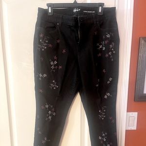 Black pants with flower prints all over